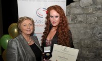 Bridget McDonagh receives her Award from Minister Fitzgerald