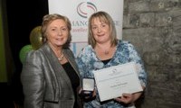 Sandra McDonagh receives her Award from Minister Fitzgerald