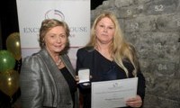 Bridget McInerney receives her Award from Minister Fitzgerald