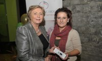 Minister Fitzgerald presents Priscilla McDonagh with a raffle prize of an MP3 player