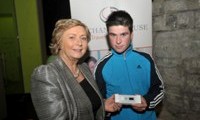 Minister Fitzgerald presents John Reilly with a raffle prize of an MP3 player