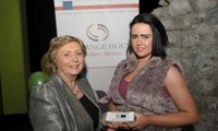 Minister Fitzgerald presents Cassie Stokes with a raffle prize of an MP3 player