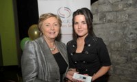 Minister Fitzgerald presents Breda Stokes with a raffle prize of an MP3 player