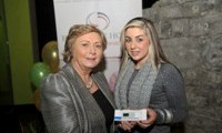 Minister Fitzgerald presents Natalie McDonagh with a raffle prize of an MP3 player