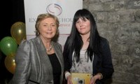 Minister Fitzgerald presents Cathleen Joyce with a raffle prize of a digital camera