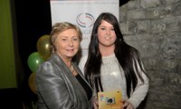 Minister Fitzgerald presents Donna Stokes with a raffle prize of a digital camera