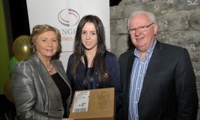 Minister Fitzgerald and Des McCormack, Exchange House Board Member, presents Leanne McDonnell with the raffle top prize of an iPad
